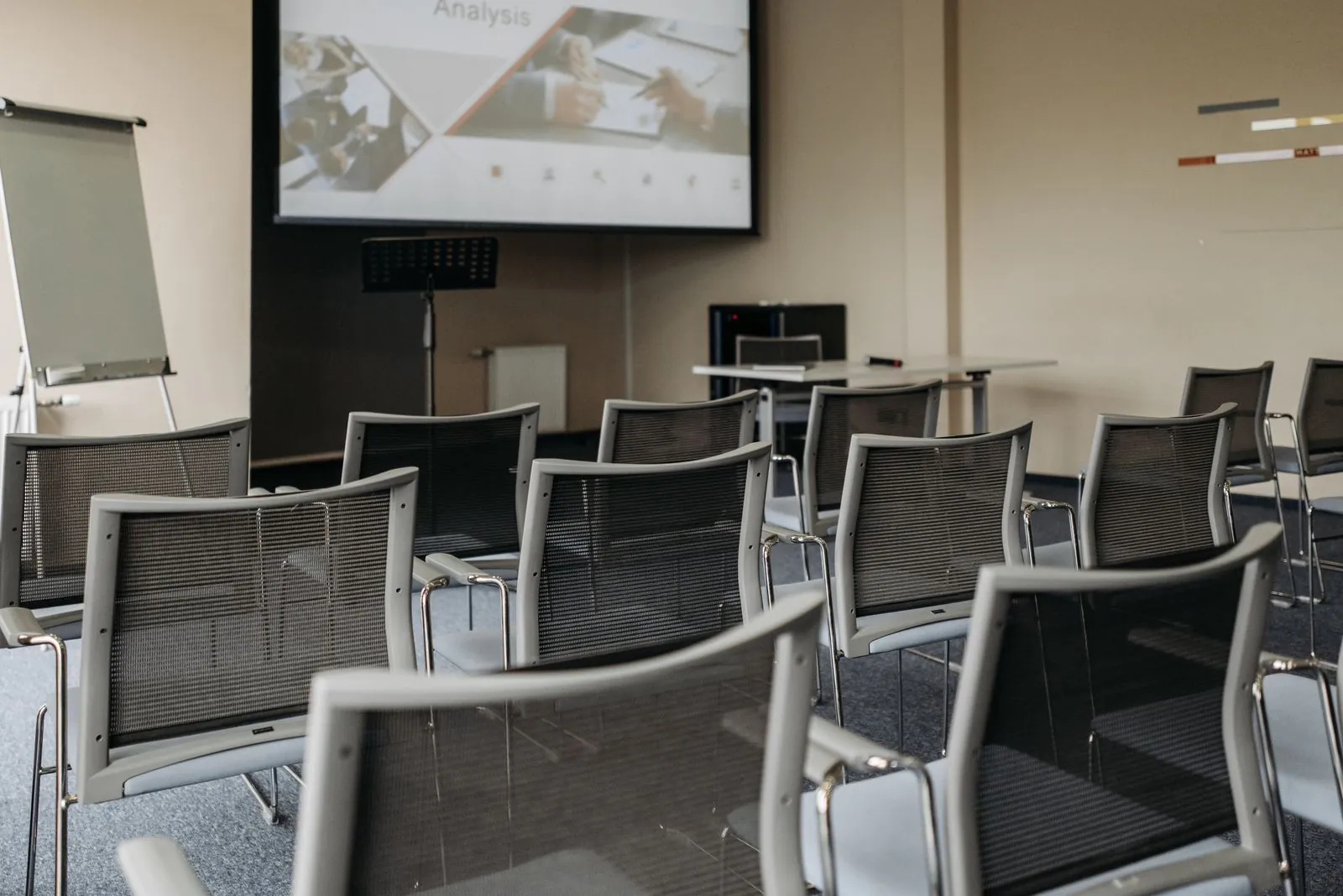 Conference room set up with chairs and presentation screen. Photo by Pavel Danilyuk.