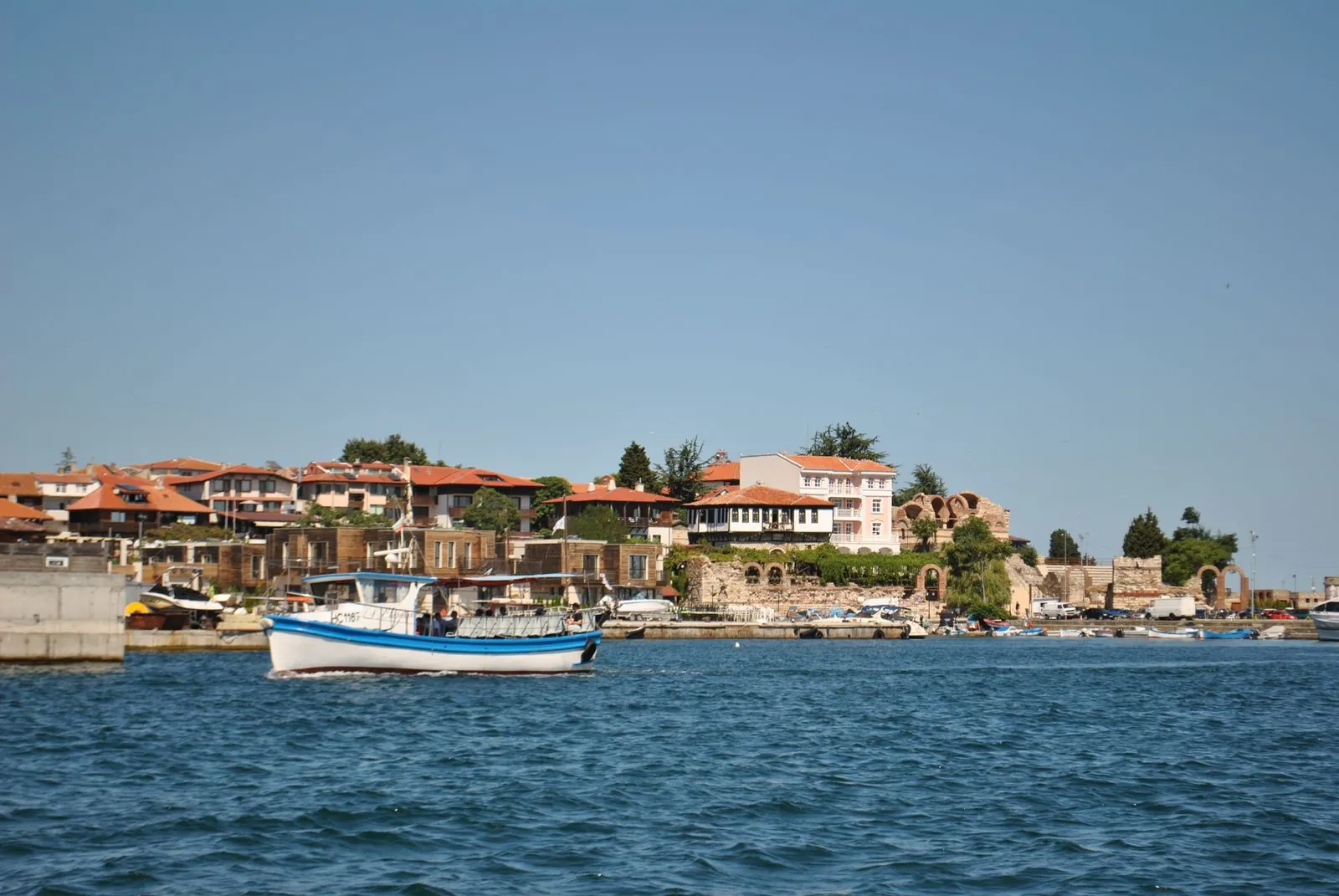 Historic waterfront of Nessebar old town with a fishing boat, Bulgaria. Photo by Valeria Drozdova.