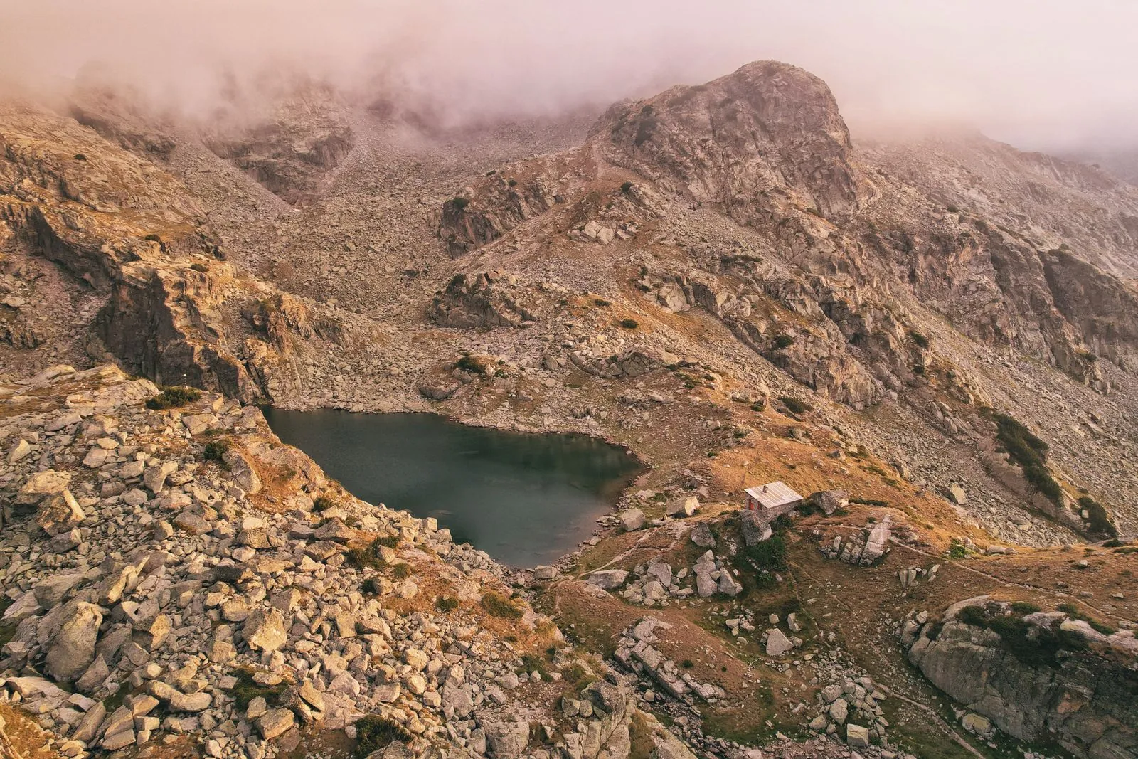 Alpine lake among rocky peaks and fog in the Rila Mountains. Photo by Kristian Aleksandrov.